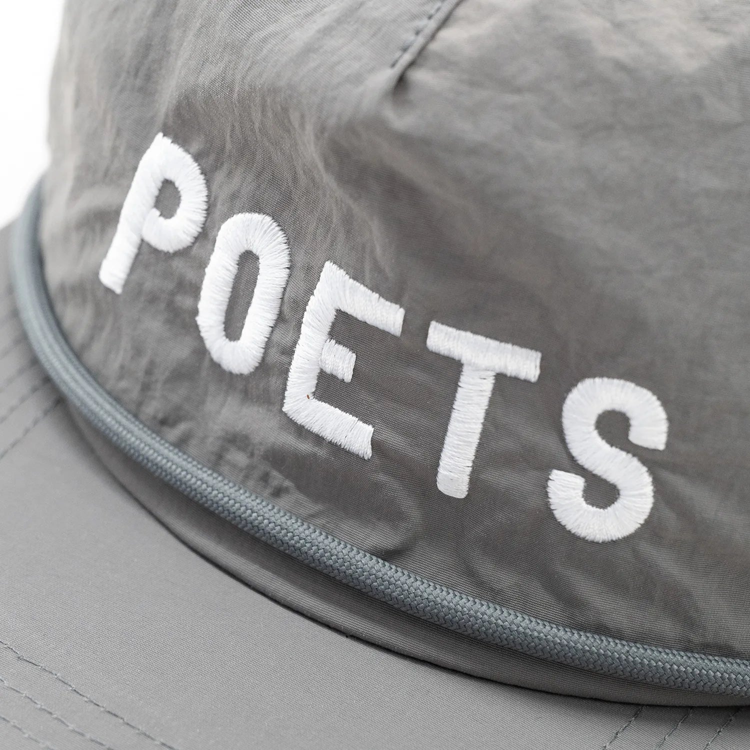 フロントに刺繍ロゴが入ったPOETS(ポエッツ)のナイロンキャップ「CAPPY CAP」のGREYカラーのフロントデザインの写真