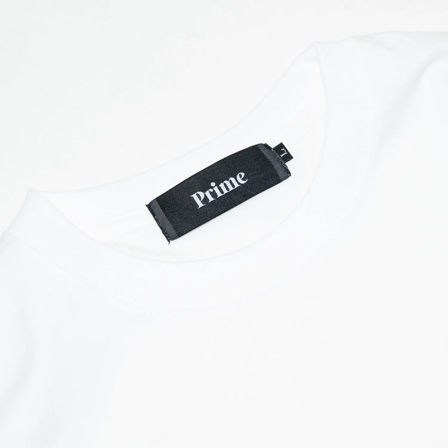PrimeのロングスリーブTシャツ「PRIME GALLERY LOGO L/S TEE」のWHITEカラーの襟裏のブランドタグ