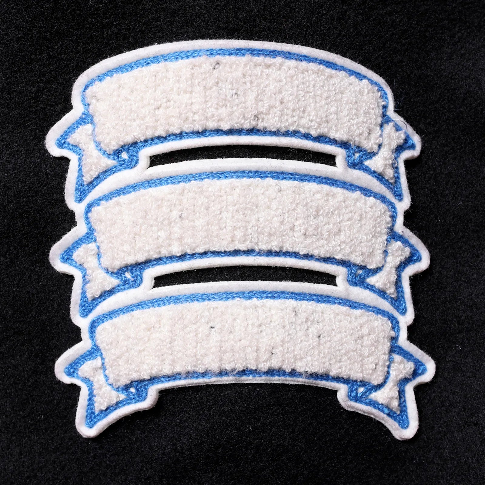 Liberaiders(リベレイダース)の肉厚なバーシティジャケット「LR VARSITY JACKET」のBLACKカラーの左腕のワッペンの写真