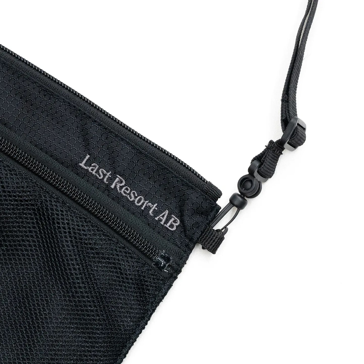 LAST RESORT ABのBLACKカラーのナイロン製小型ショルダーバッグ「LIFT OFF BAG」右上に刺繍で入るロゴデザインの写真