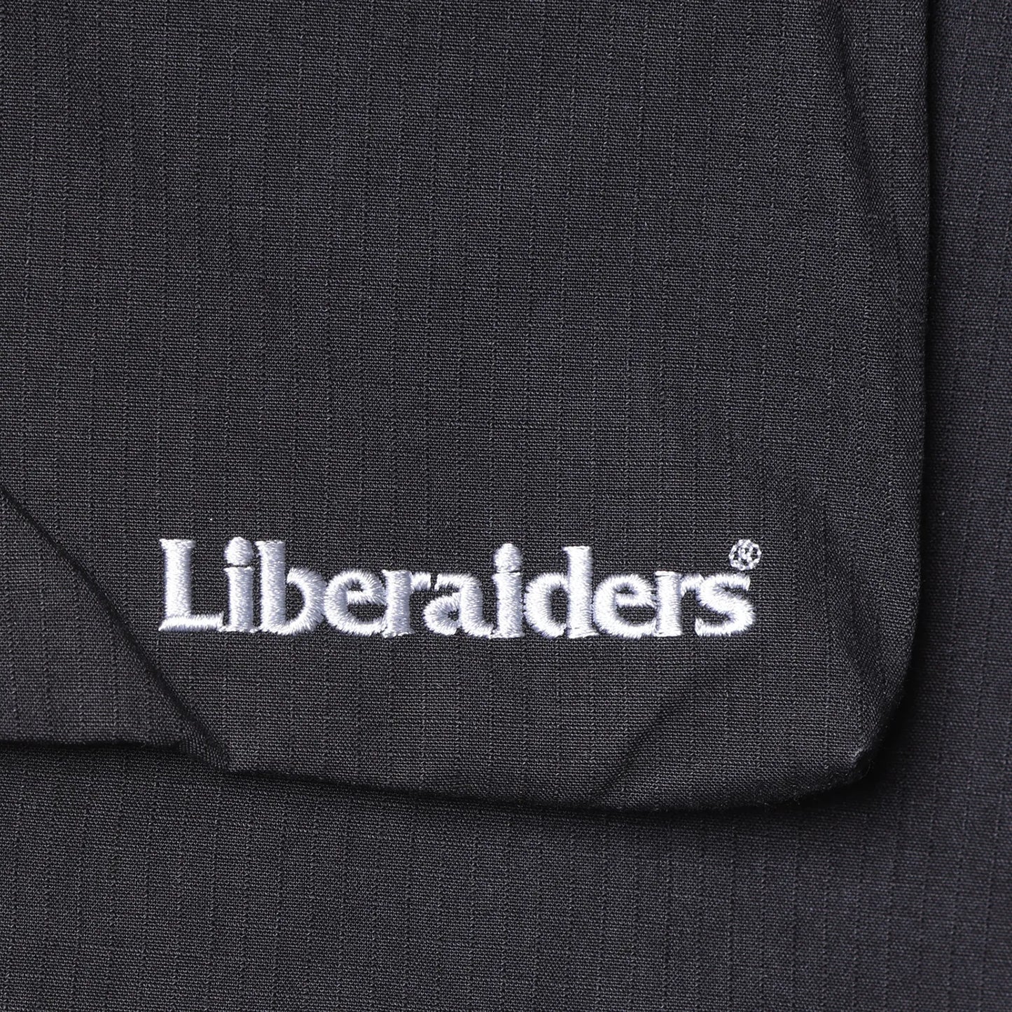 Liberaiders(リベレイダース)の高機能ナイロンショーツ「CORDURA RIP UTILITY SHORTS」のBLACKカラーの刺繍で入るブランドロゴの写真