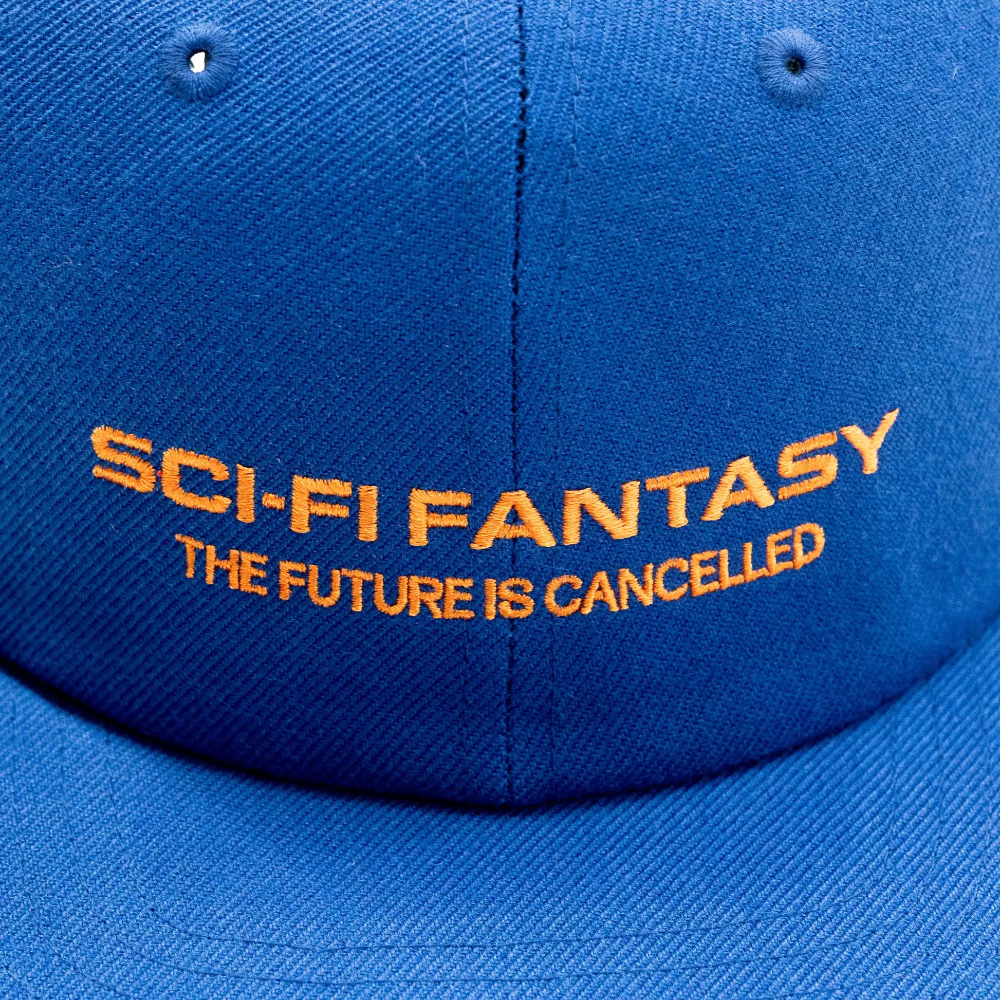 「SCI-FI FANTASY」のキャップ「FUTURE IS CANCELLED CAP」のBLUEカラーの正面デザイン写真
